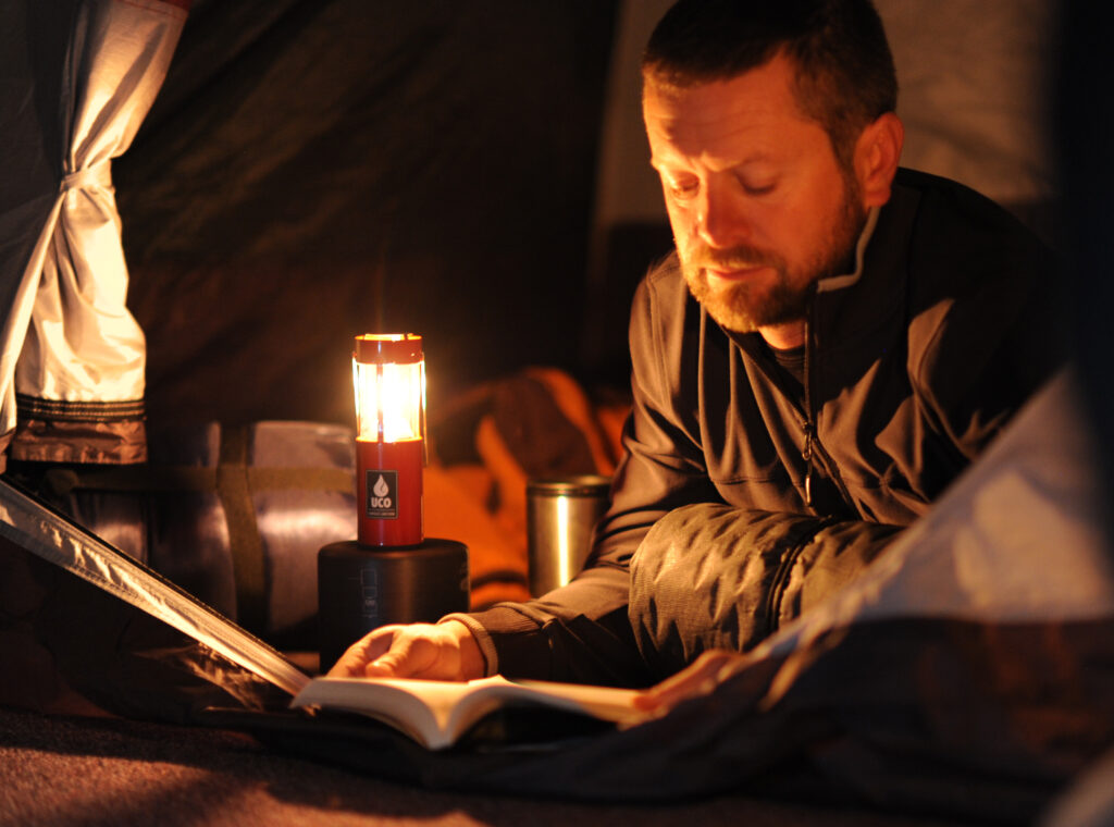 man reading by candle light